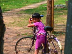 Myanmar photos - young girl, big bike