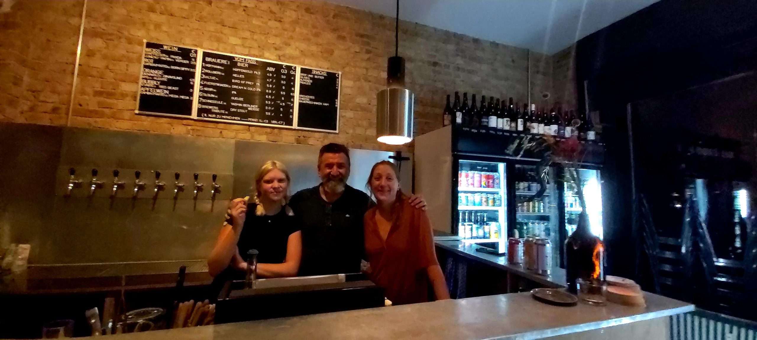 Three people behind thebar at Lager Lager craft beer bar in Berlin