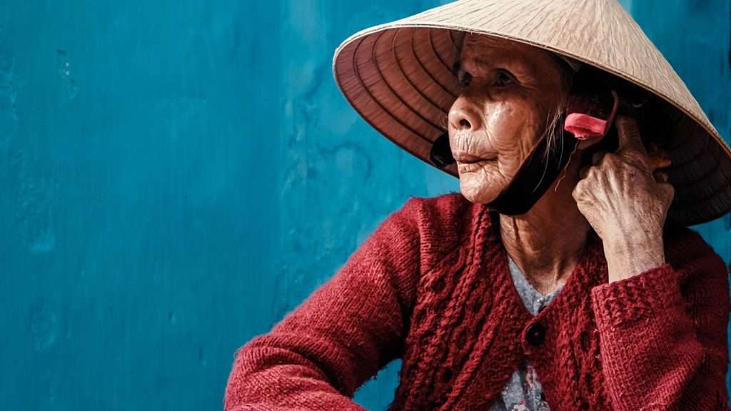 Old Vietnamese lady in a Non-La - traditional conical hat