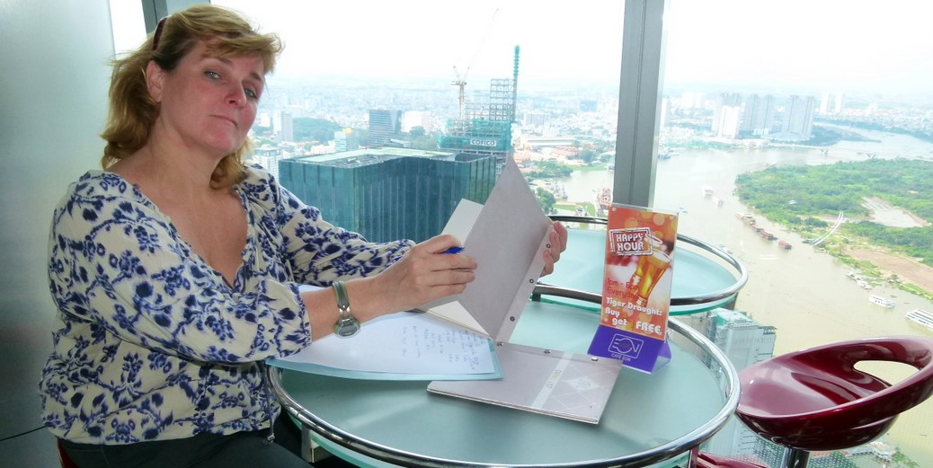 Sharyn Nilsen looking at the drinks menu at the Helio Bar at the top of Bitexco Tower.