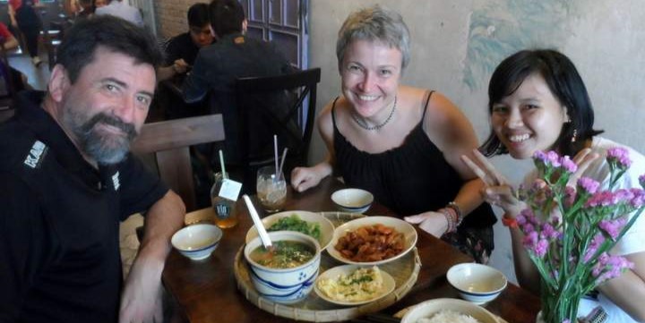 Three people enjoying a traditional lunch in Ho Chi Minh City