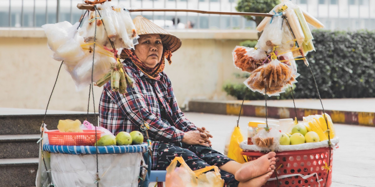 Street Scene in Ho Chi Minh City. Older Lady selling street food.