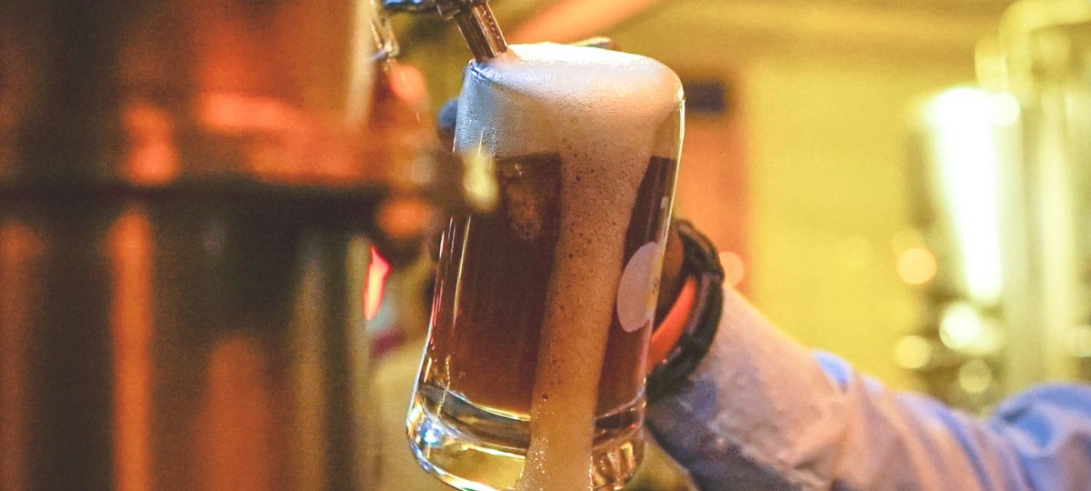 Server pouring a craft beer 