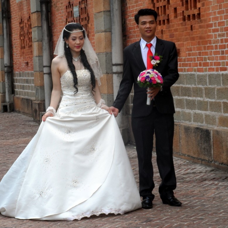  A couple having wedding photos taken outside Saigon's Notre Dame Cathedral