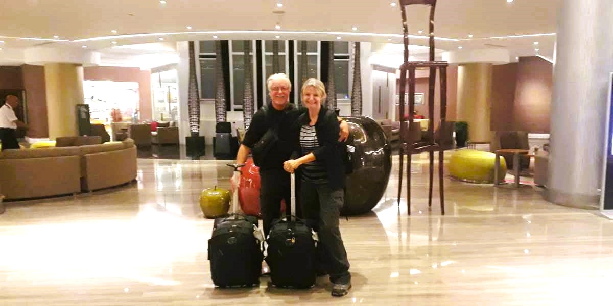 Jane and Duncan from To Travel Too with their carry on luggage.